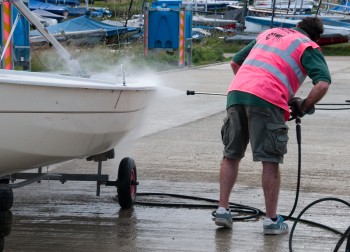Jet washing a boat to remove invasive species